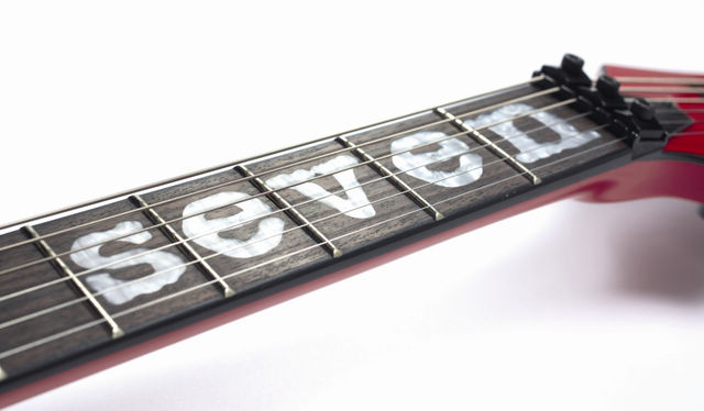 blank The rosewood fingerboard is inlaid with the legend 'Seven'.